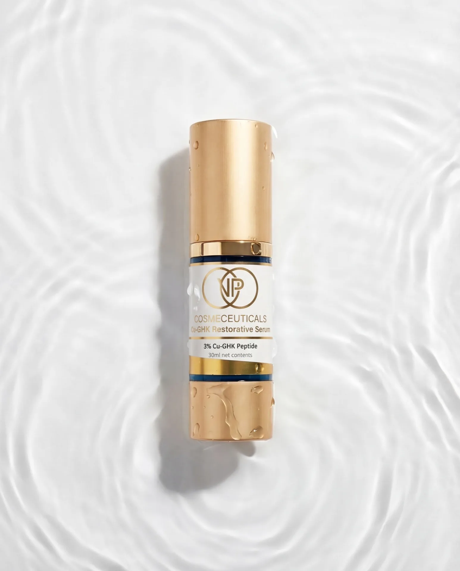 Applying GHK-Cu restorative serum to cheek and jawline